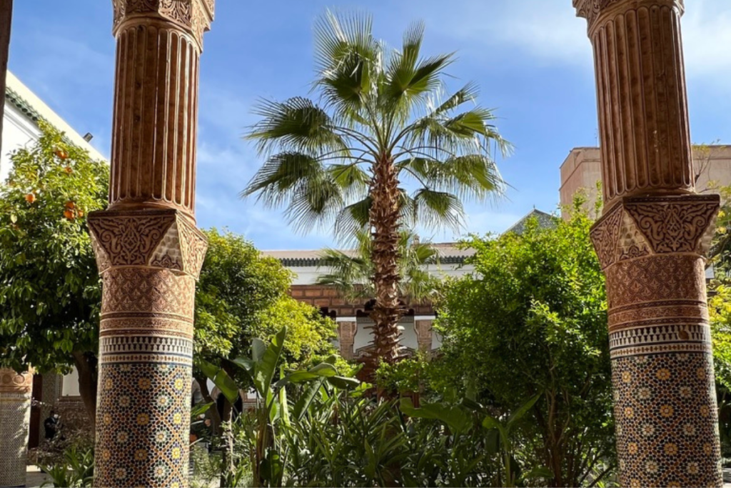 Palm trees and garden courtyard inside traditional Moroccan riad architecture