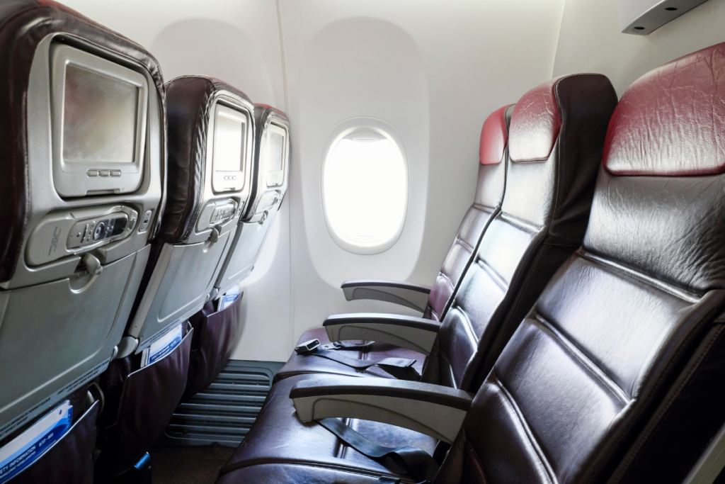 Empty airplane seats beside a window
