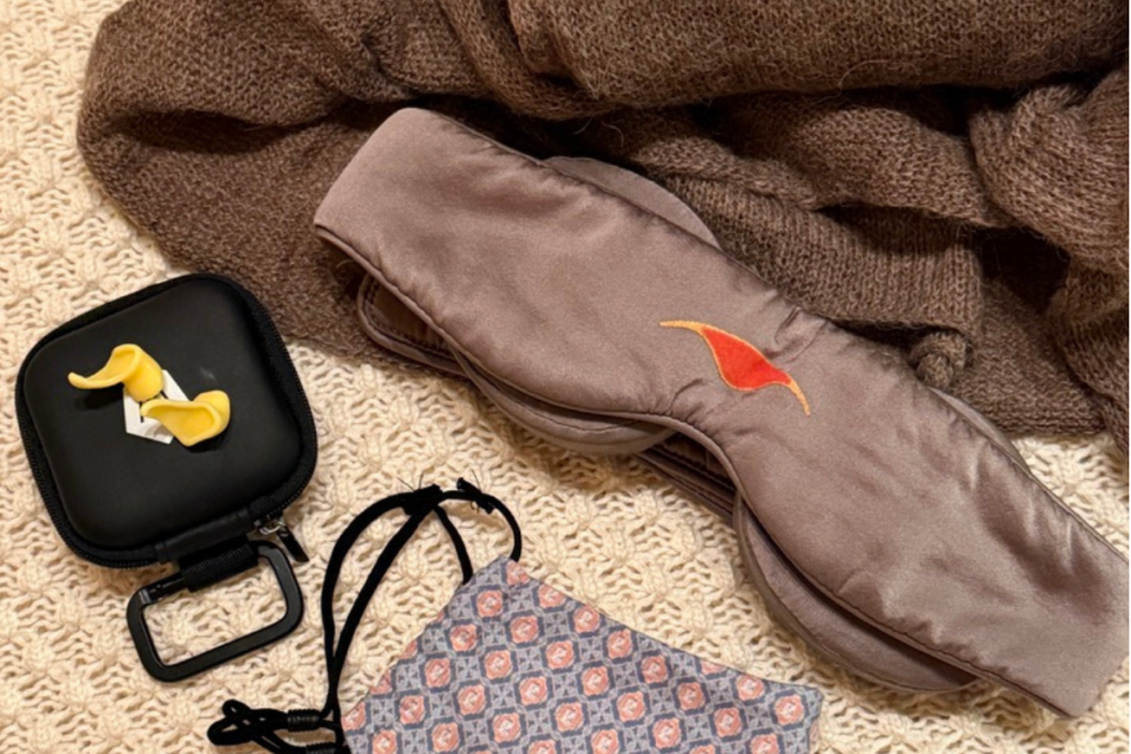 Eye mask, custom earplugs, scarf and face mask for sleeping on a long-haul flight
